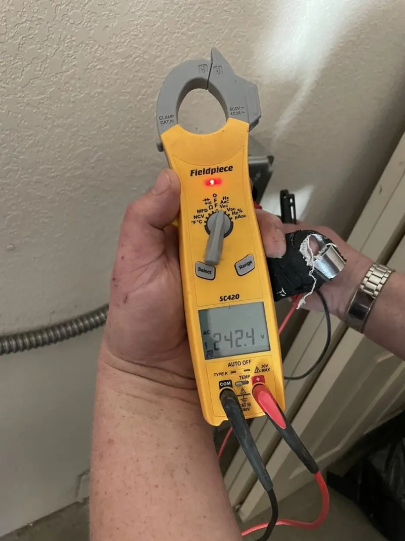 Voltage testing with clamp meter during Ceiling Fan Installation in Farley